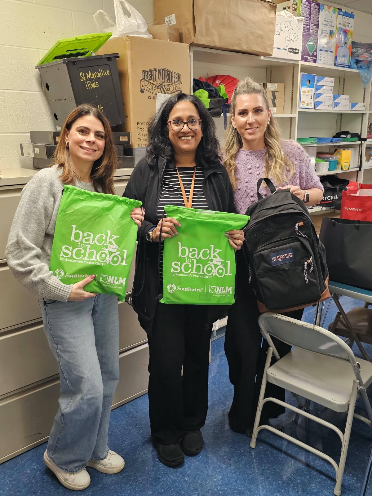 Backpacks and school supplies being delivered to school representatives