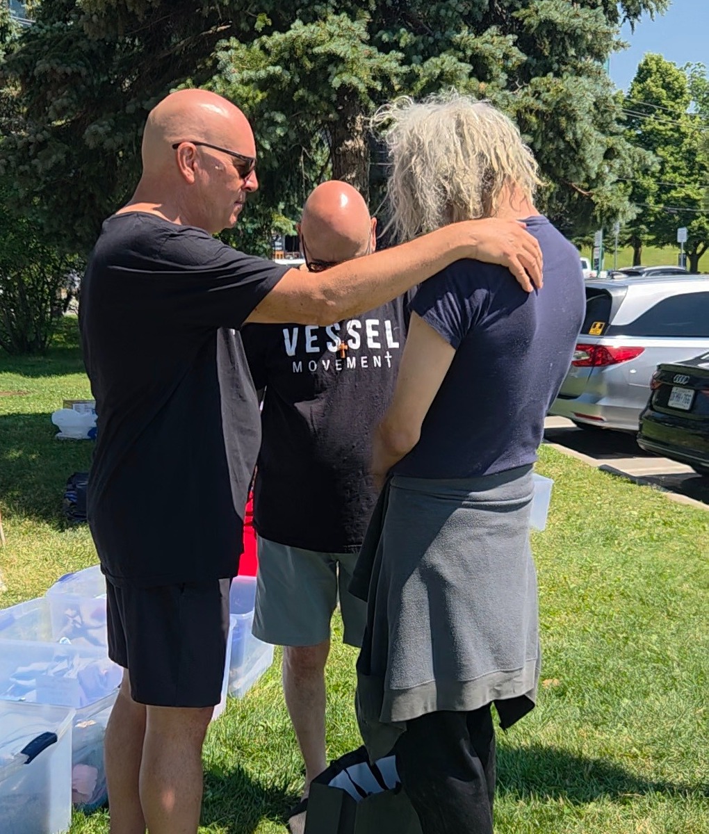 Vessel Movement volunteers sharing a moment of prayer and support