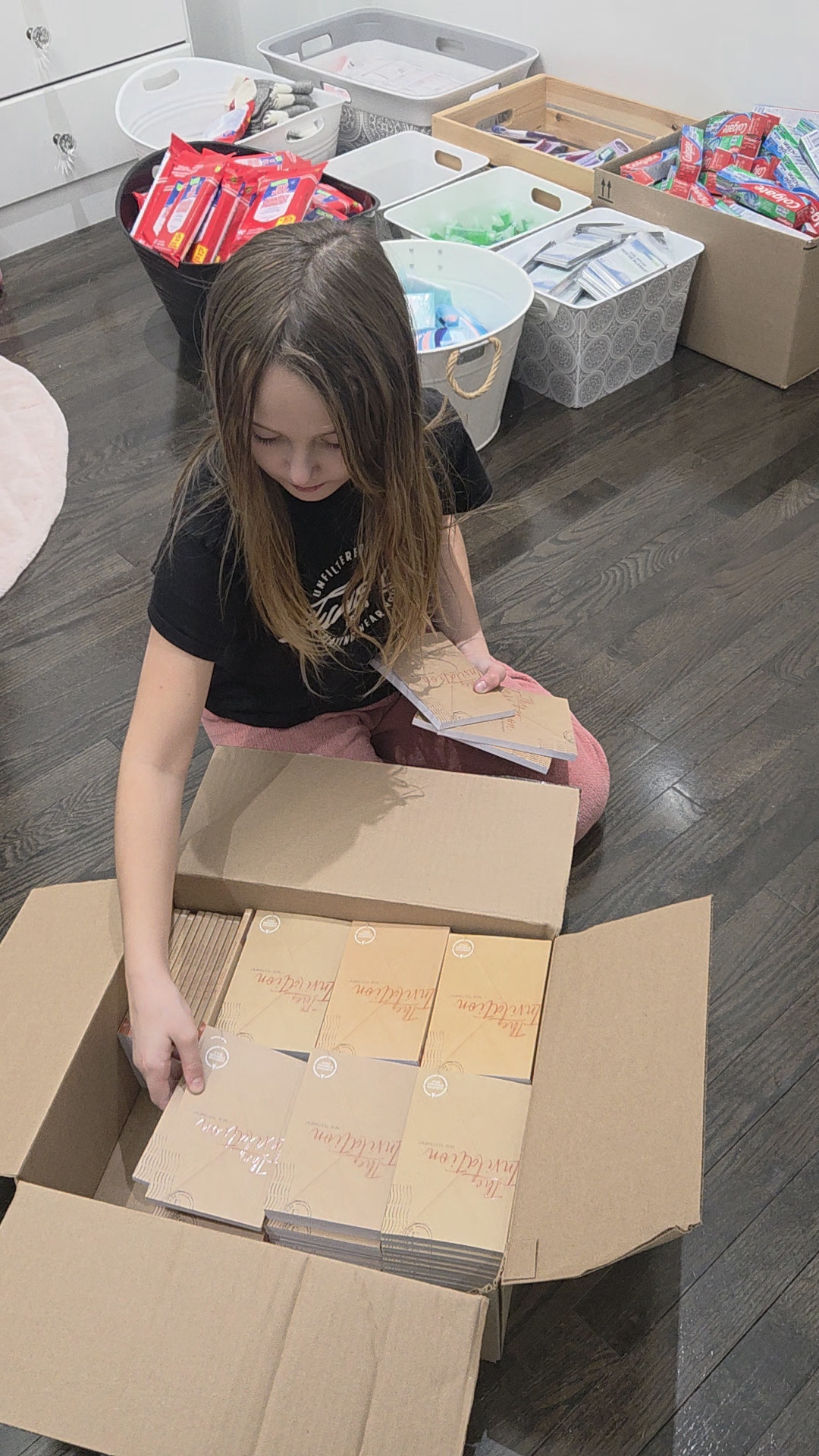 A child organizing donated care supplies for community outreach