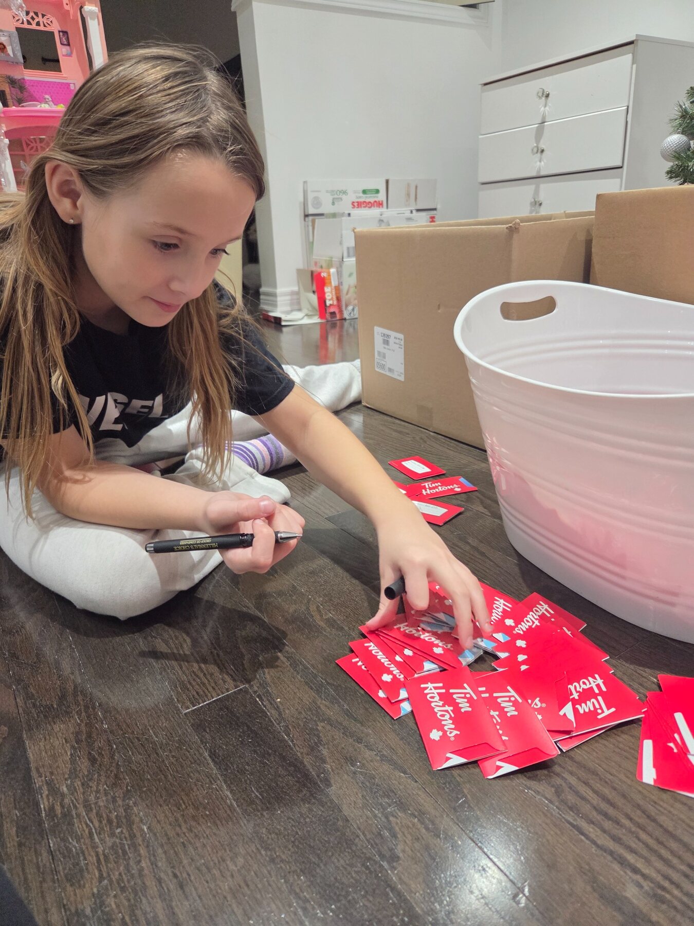 A child preparing donated gift cards for outreach