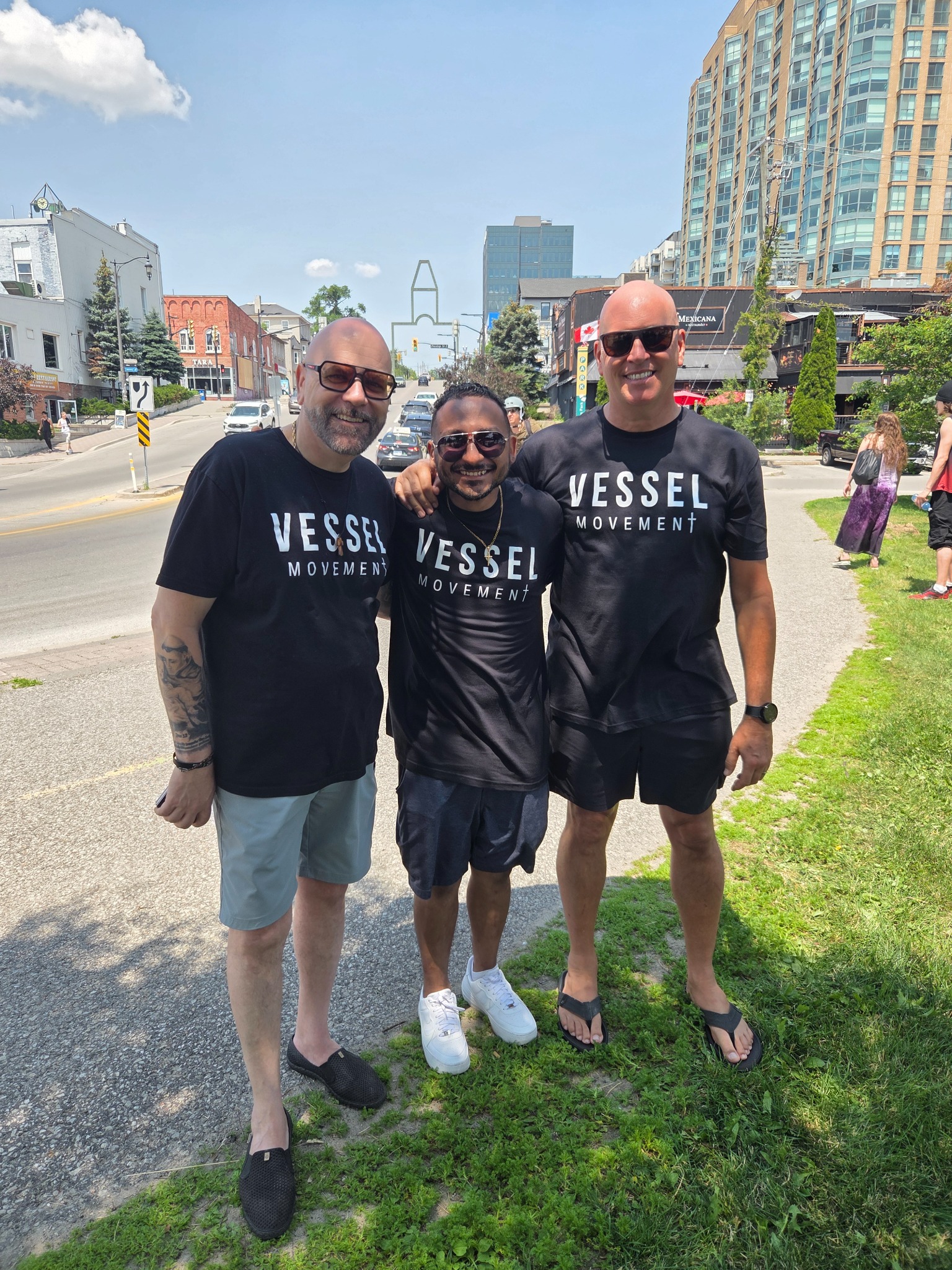 Three men wearing Vessel Movement T-shirts
