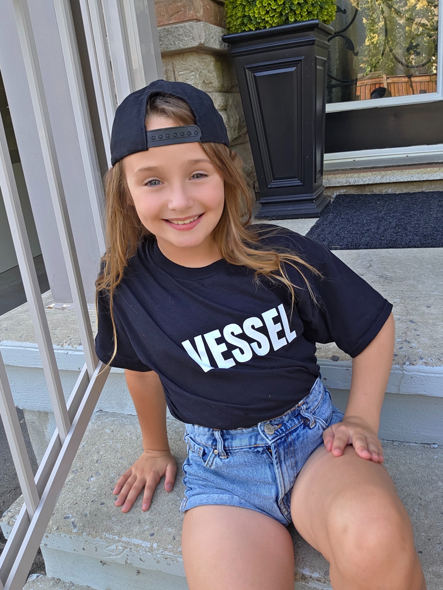 A child proudly wearing a Vessel shirt